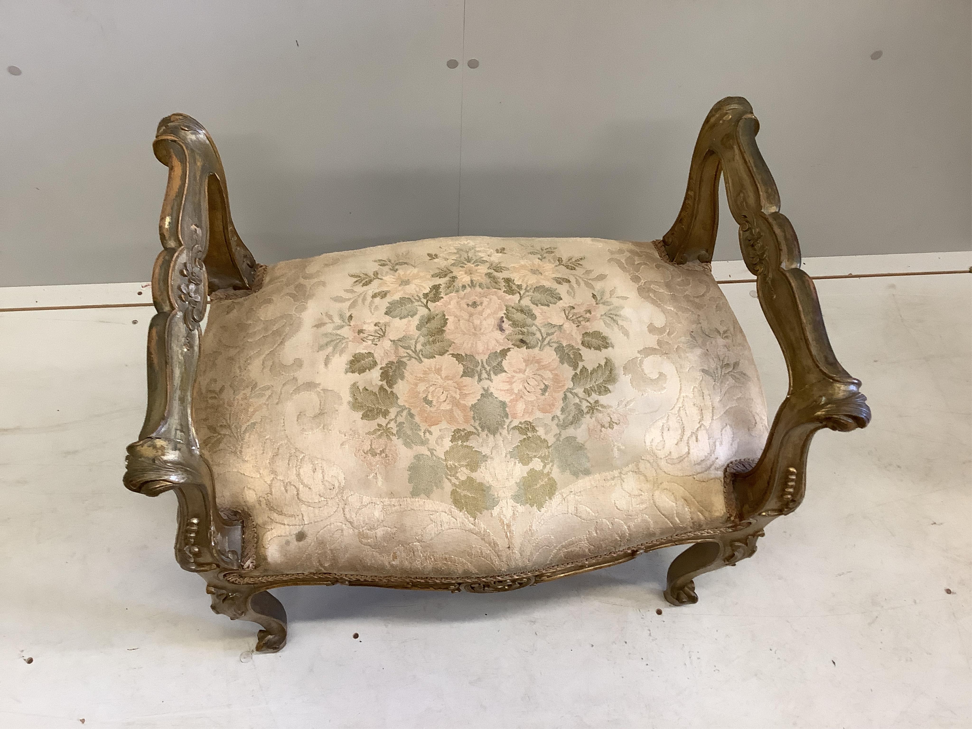 A 19th century French carved giltwood and composition dressing stool, width 62cm, depth 41cm, height 62cm. Condition - fair